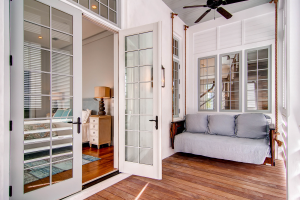 Rosemary Beach house master bedroom with wooden porch swing
