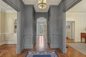 Spacious Buckhead Atlanta foyer with ornate wood paneling welcomes guests in style.