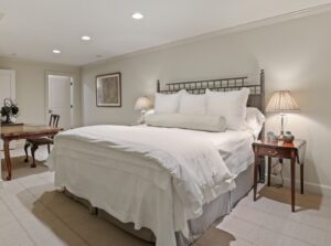 Guest bedroom with Asian bamboo design headboard.